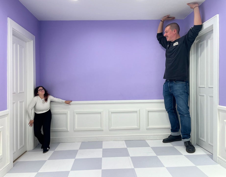 Illusion at the museum where one person appears to be very tall and the other very short