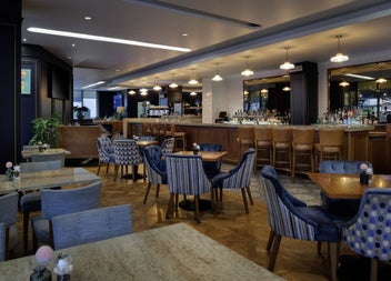 A modern bar with tables and chairs and lounge seating