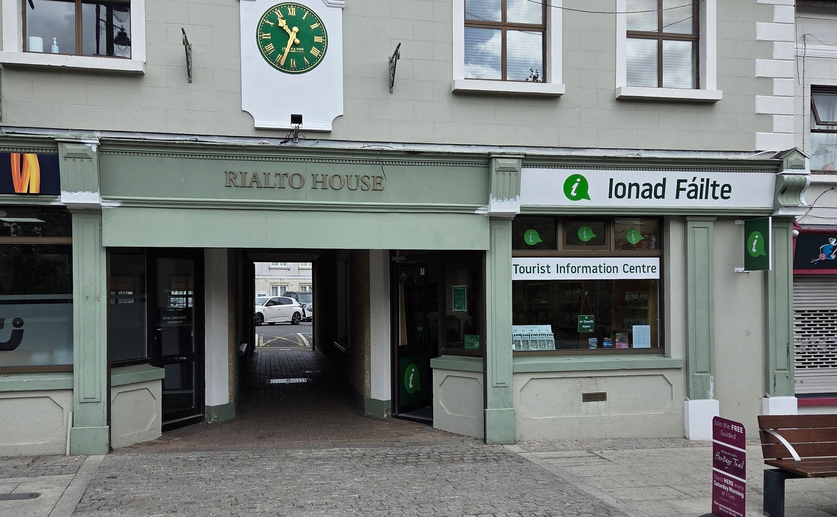 Exterior of a tourist office with branding on the window