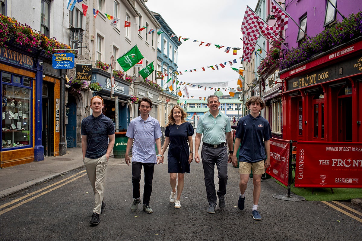 A family strolling along a colourful city street