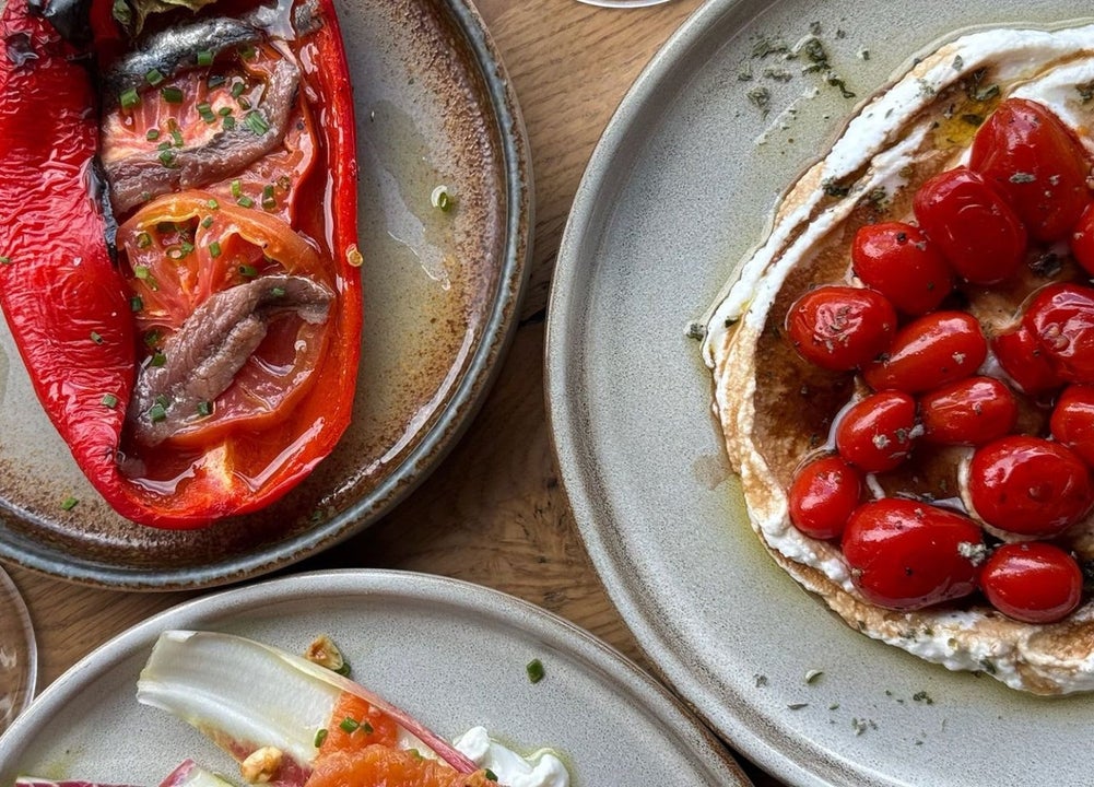 A roasted red pepper dish and a cherry tomato plate