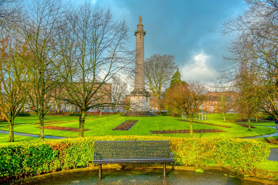 A bench with a Doric column in the background
