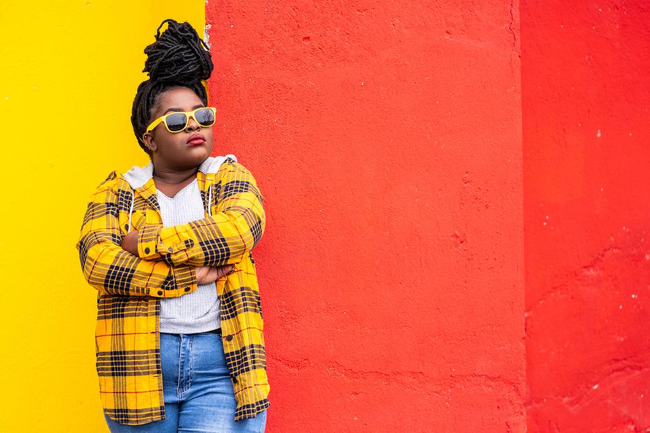 Lady standing against a wall