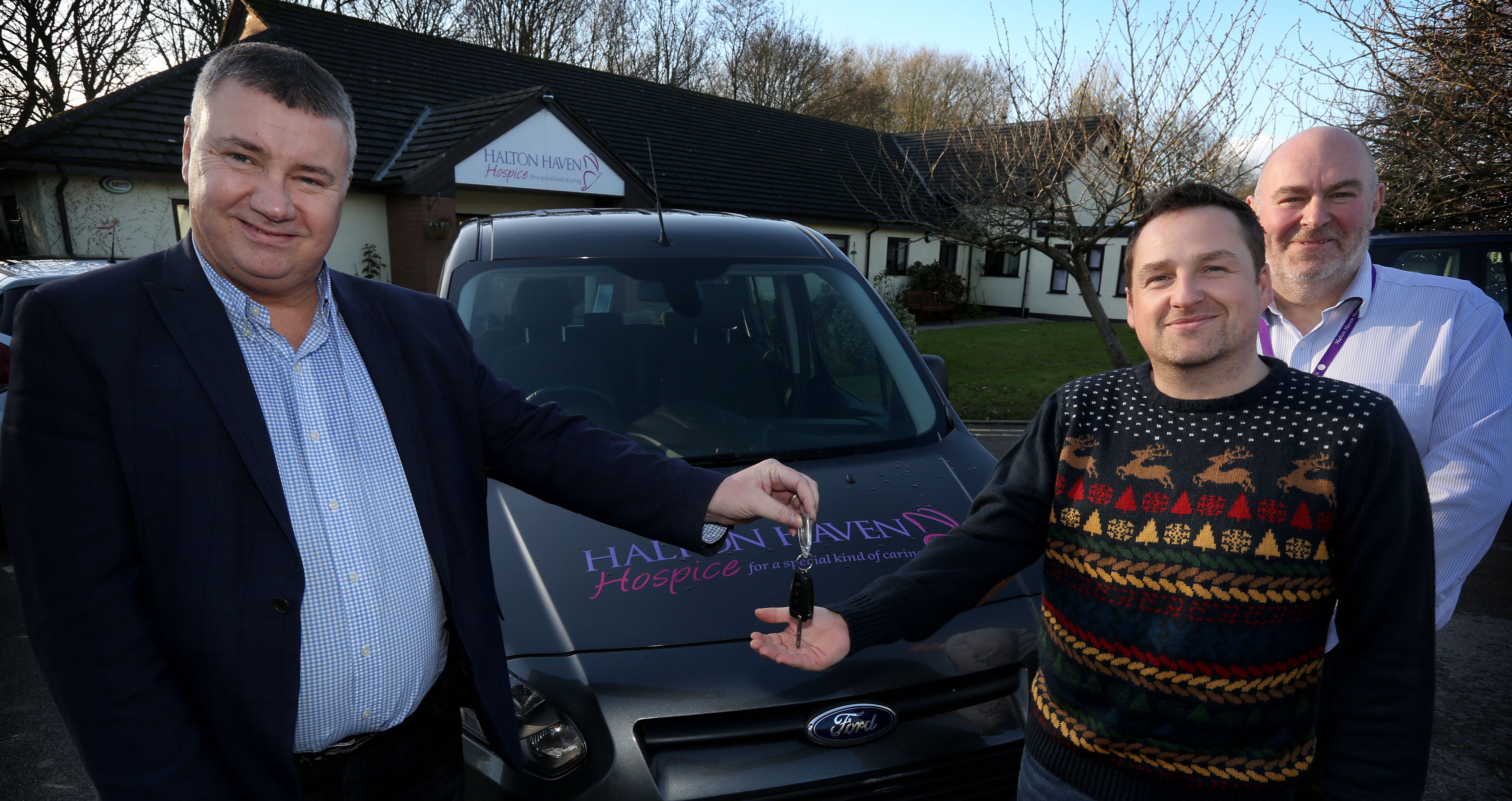 Halton Haven Hospice staff receiving a new Ford Tourneo Connect donated by Merseyflow.