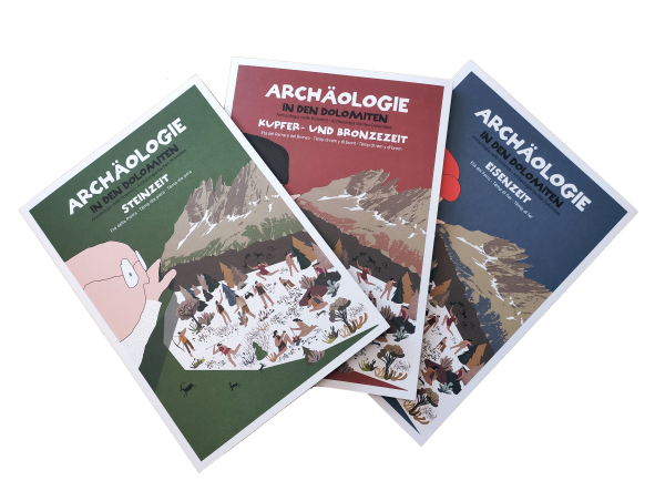 La Ntendënza ladina nvieia ala prejentazion di trëi libri sun l’archeologia dla Dolomites cun tesć per tudësch, talian, gherdëina y badiot cun cufri cun material da pië ite. (Foto: USP/Ntendënza ladina)