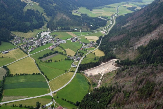 Die Luftaufnahme zeigt rechts den Damm am Hoferbach in Antholz samt Auffangbecken dahinter. Die durchgeführten Arbeiten bringen der Bevölkerung in Antholz-Niedertal mehr Sicherheit. LPA/Agentur für Bevölkerungsschutz)