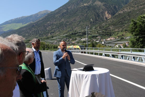 Il sindaco di Laces, Mauro Dalla Barba, con il microfono in mano accanto all'assessore provinciale Alfreider: “Oggi è un giorno speciale per il nostro Comune. Dopo mesi di lavori, possiamo finalmente inaugurare il ponte, la cui esistenza per molti sembrava scontata. Un ponte è molto più di una semplice struttura di acciaio e cemento. Collega persone, località, luoghi di lavoro e di vita. È fonte d'incontri e favorisce lo sviluppo sociale ed economico. (Foto: USP/Dipartimento Infrastrutture e Mobilità)