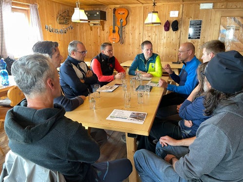 Landesrat Bessone (grüne Jacke) im Gespräch mit Technikern und Hüttenbetreibern (Foto: LPA/Landesvermögensabteilung)
