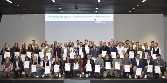 Foto di gruppo alla cerimonia di consegna dei diplomi: i 13 maestri artigiani donne, i 38 maestri artigiani uomini, i 6 specialisti commerciali donne e i 2 specialisti commerciali uomini con la direttrice dell'Ufficio Apprendistato e formazione dei maestri professionali Cäcilia Baumgartner (davanti, prima da sinistra) e l'assessore provinciale Philipp Achammer (davanti, secondo da sinistra). (Foto: USP/Ufficio Apprendistato e formazione dei maestri professionali)