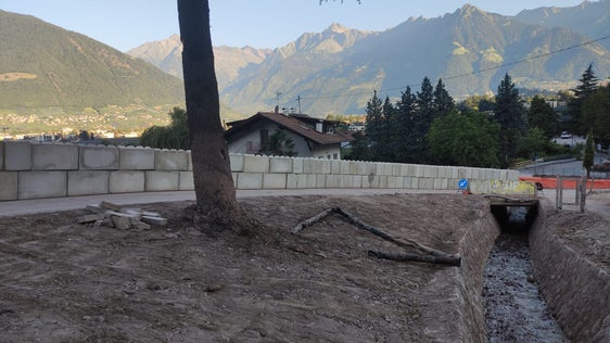 Im Bereich oberhalb der Gebäude hat das Amt für Wildbach- und Lawinenverbauung Süd einen provisorischen Schutzdamm aus Betonblöcken errichtet, er ist etwa 70 Meter lang und 1,60 Meter breit. (Foto: LPA/Amt für Wildbach- und Lawinenverbauung Süd)