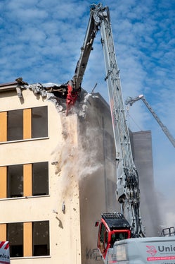 L'impressionante operazione di abbattimento dell'edificio che un tempo ospitava le scuole elementari Longon, nell'omonima via, a Bolzano. (Foto: USP/Fabio Brucculeri) 