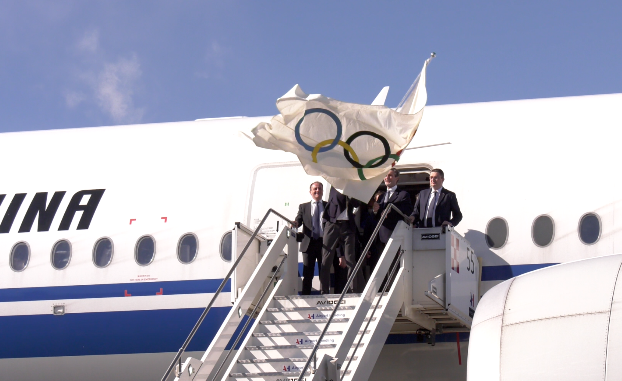 L'assessore Vettorato sulla scaletta dell'aereo che ha portato la bandiera olimpica in Italia. (Foto ASP/Scampini)