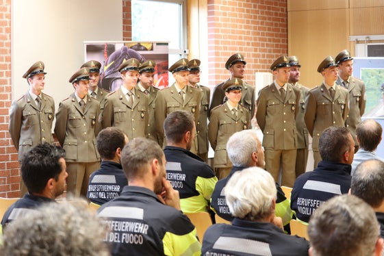 An der Feierstunde für die Absolventen und die Absolventin des elften Ausbildungskurses in einem Lehrsaal der Berufsfeuerwehr nahmen auch langgediente Feuerwehrleute und Mitarbeiterinnen und Mitarbeiter der Verwaltung teil. (Foto: LPA/Maja Clara)