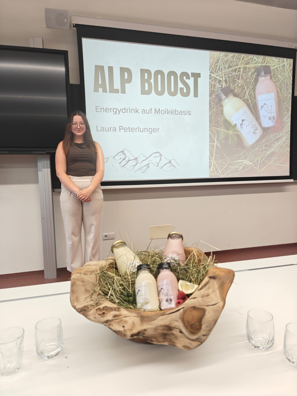 Una studentessa del quarto anno del corso di Tecnologie alimentari della Scuola professionale Laimburg durante la sua presentazione finale: il suo Alp Boost è una bevanda energetica a base di siero di latte. (Foto: USP/Scuola professionale di Laimburg)