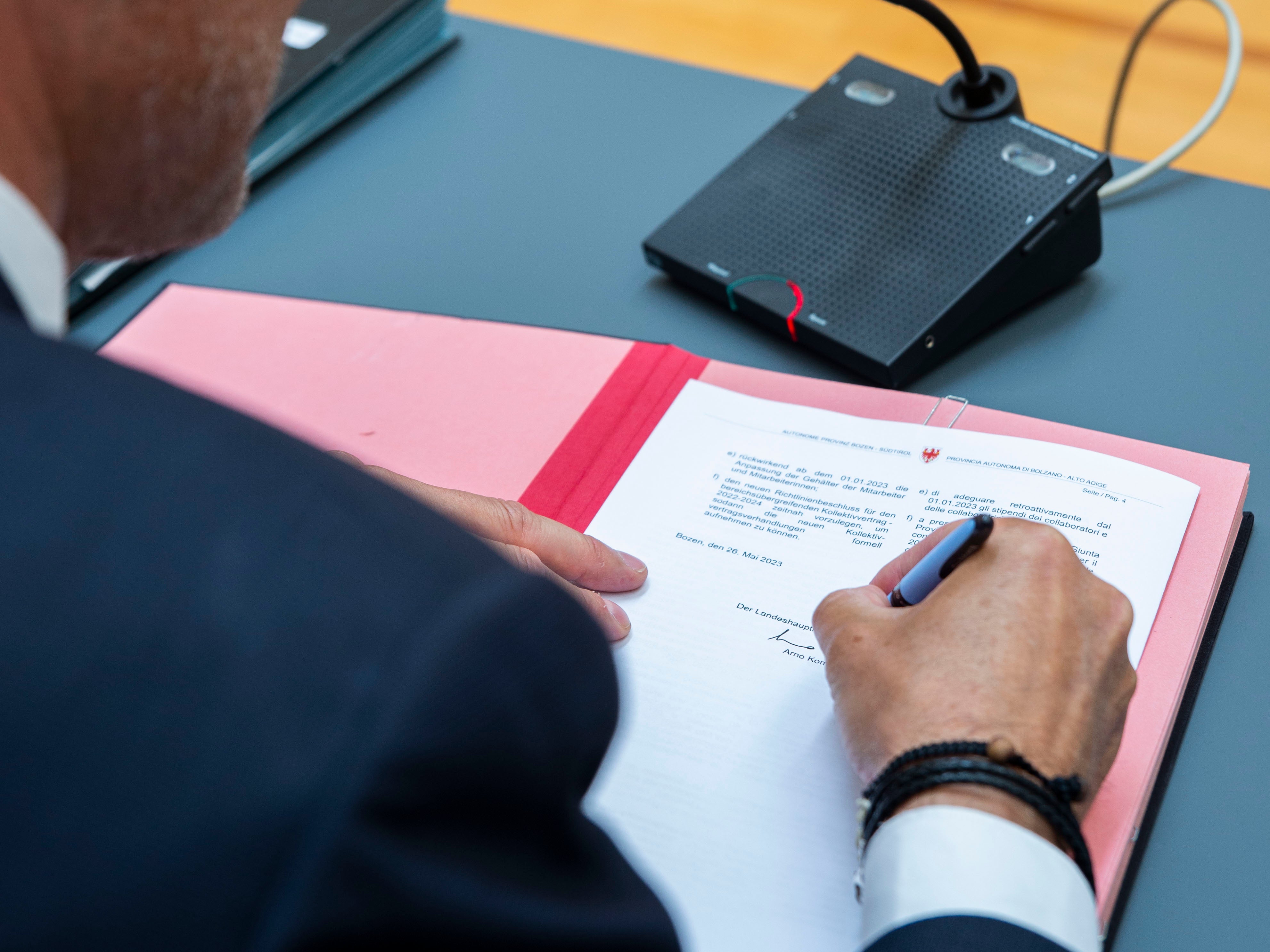 Promessa mantenuta: Il presidente Arno Kompatscher (nella foto mentre firma il vecchio CCI il 26 maggio 2023) si era impegnato a versare presto la compensazione dell'inflazione ai dipendenti provinciali. Il primo passo è stato fatto oggi e la prossima settimana sarà firmata la parte economica del nuovo CCI (Foto: ASP)