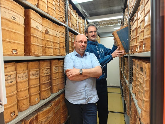Gustav Pfeifer, der Direktor des Landesarchivs (im Bild vorne), und sein Mitarbeiter Philipp Tolloi mit den historischen Archivbeständen. Heute werden die meisten digitalen Unterlagen, die auf Dauer verwahrt werden sollen, über den Dienst ParER digital archiviert. (Foto: LPA/Ursula Pirchstaller)