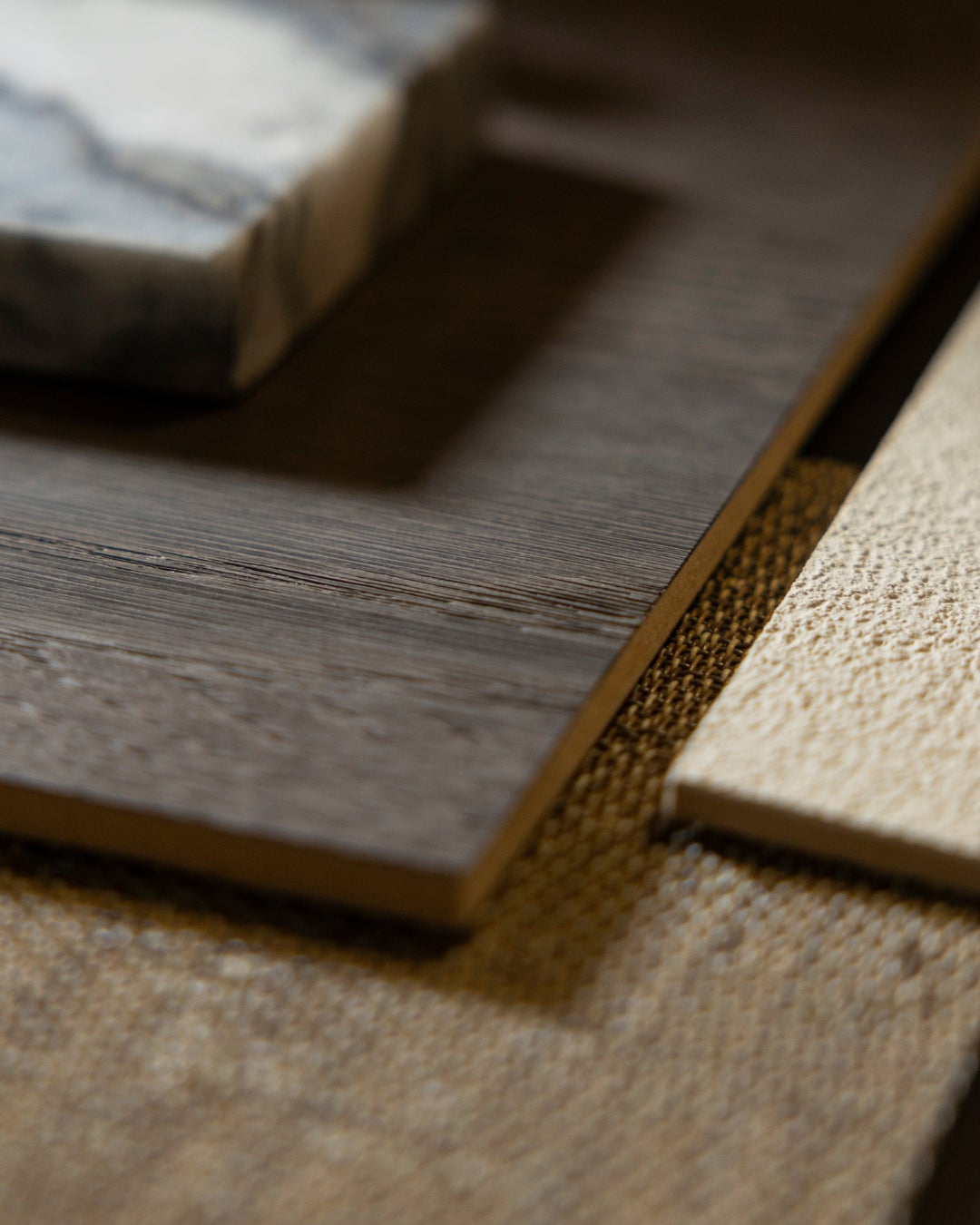 Moodboard of Querkus wood veneer collection - earthy tones - marble - dark wood - tartufo