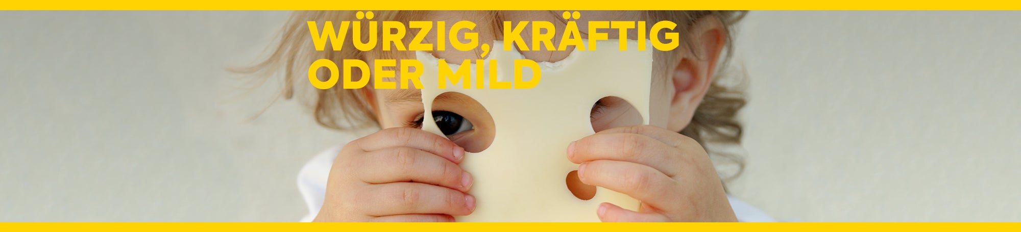 Ein kleines Kind hält eine Scheibe Emmentaler in der Hand und schaut durch die Löcher. Text: Würzig, kräftig oder mild
