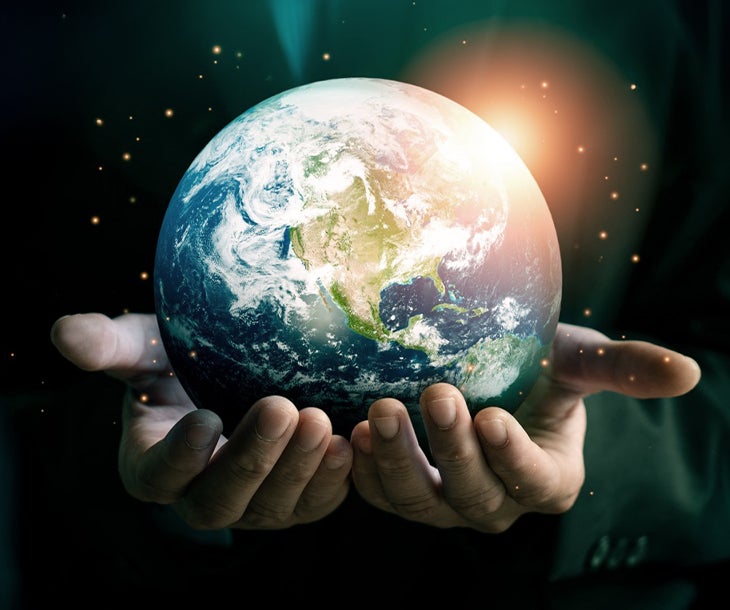 A person holding a planet