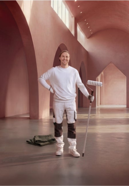 A man holding a paint roller