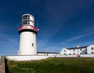 A lighthouse with a red roof