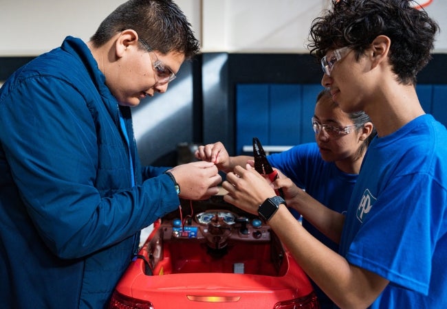 A group of people working on a machine