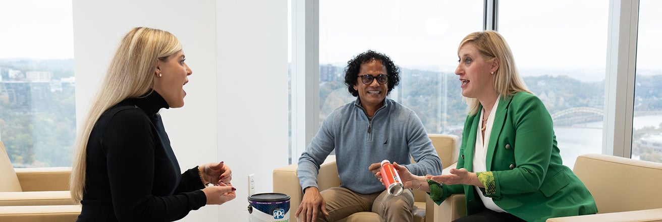 Three PPG employees discussing products