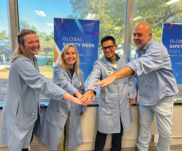 Group of PPG colleagues smiling and putting hands together