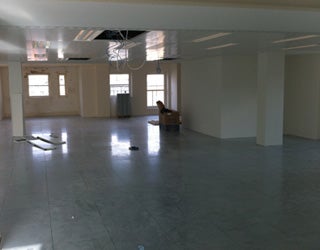 Room with several windows under restoration in a property.
