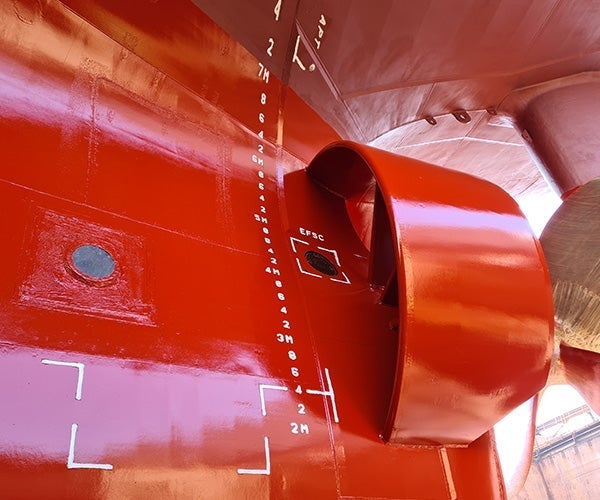 A red metal object with white markings