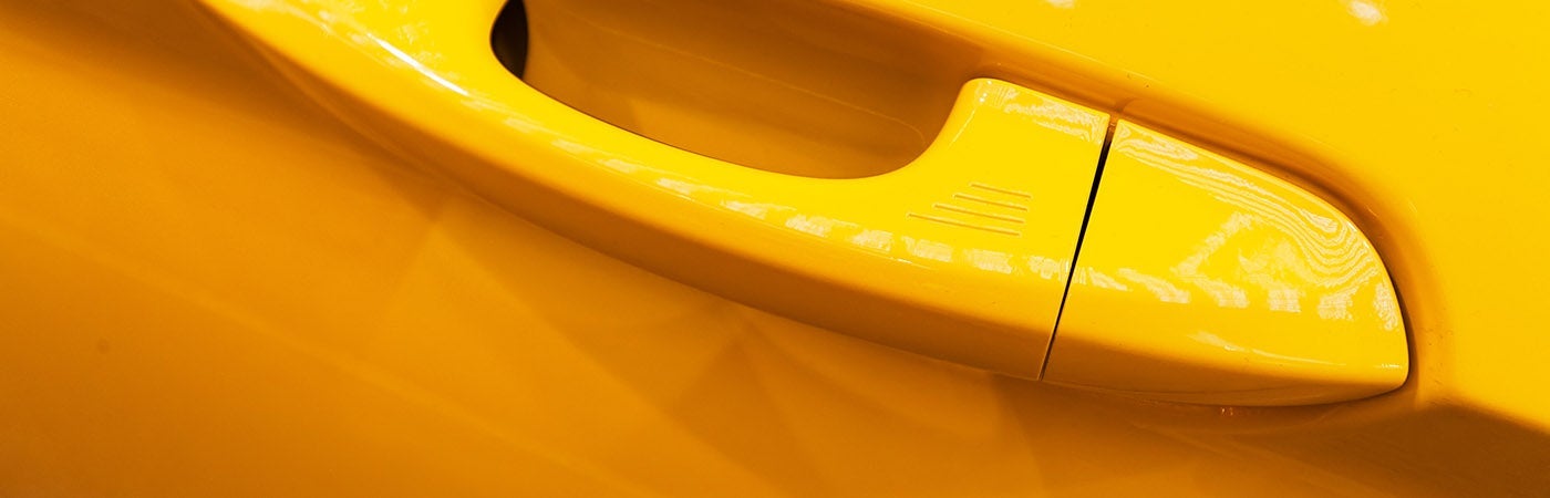 Handle of a yellow vehicle.