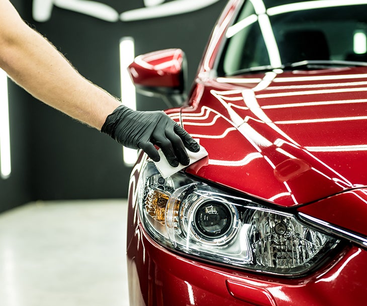 A person polishing a car
