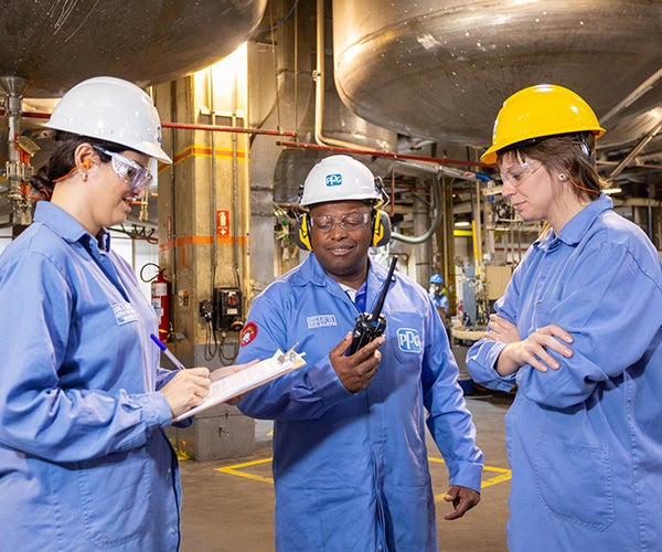 Workers with checklist in factory