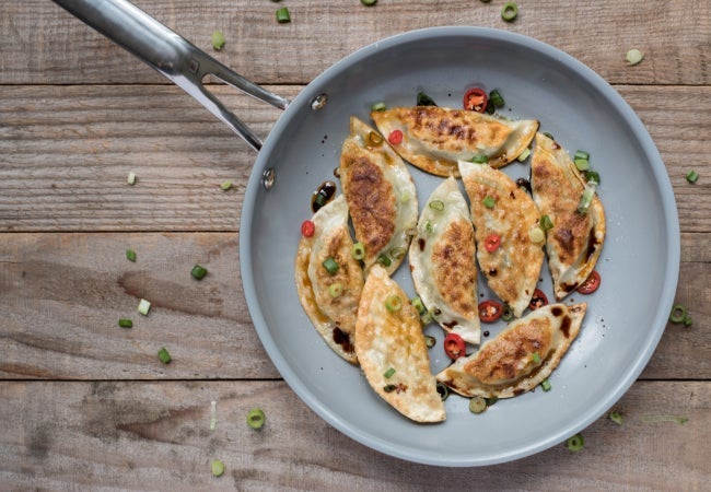 Frying pan with dumplings cookking