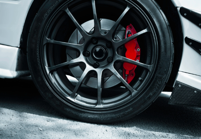 Black car wheel with red metal part