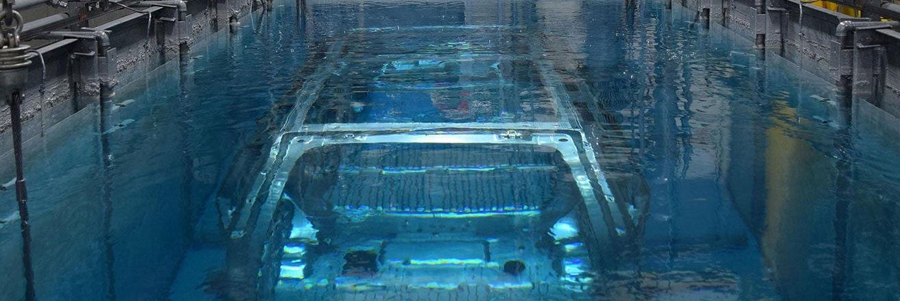 a vehicle body submerged in an automotive pretreatment bath