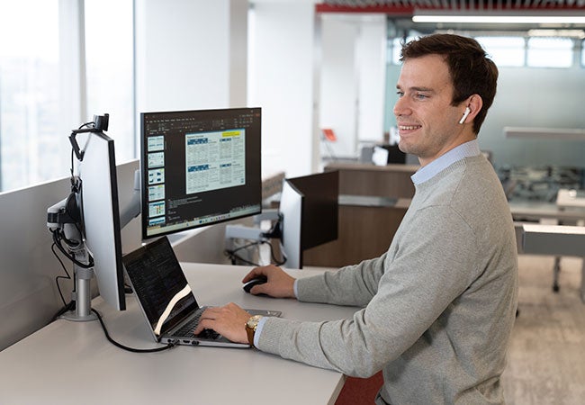 Male PPG worker inspecting data on computer
