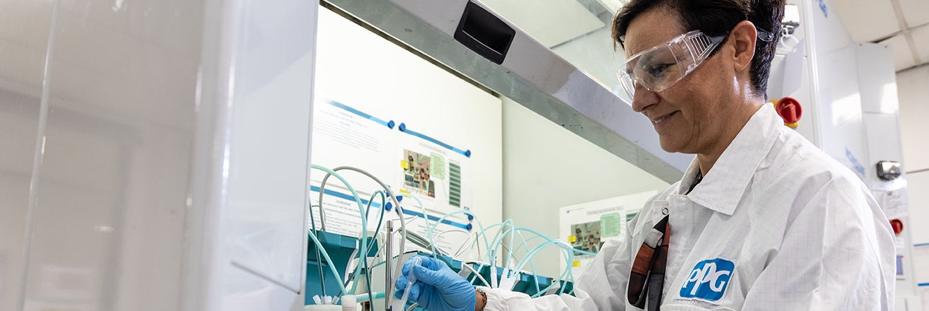 Woman working in lab wearing PPE