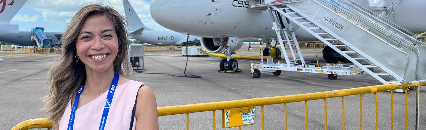 Barbara Flocchini, a PPG employee from our Aerospace business, with several airplanes in the background