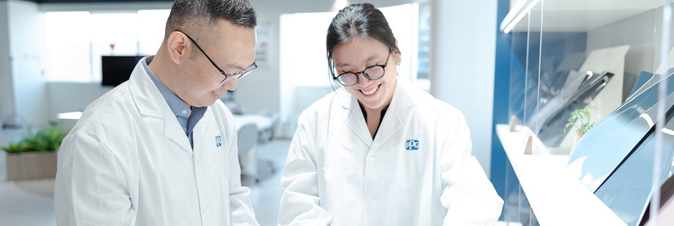 Two colleagues in lab smiling
