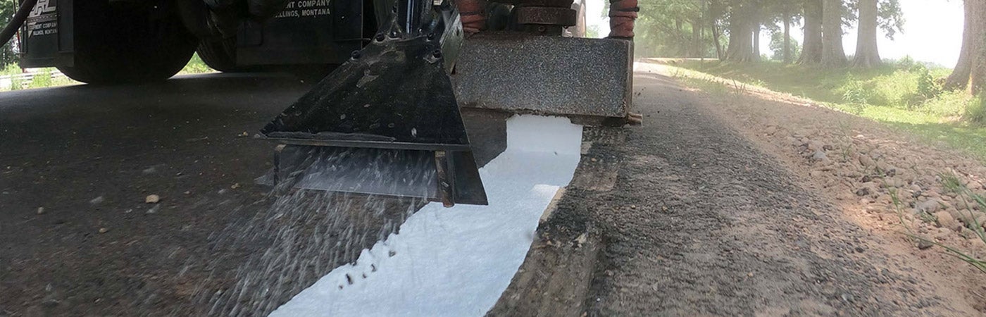 A truck applying  PAVEMARK® Hot-Applied Thermoplastic to a roadway