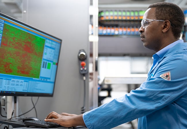 PPG worker checking data on a computer monitor