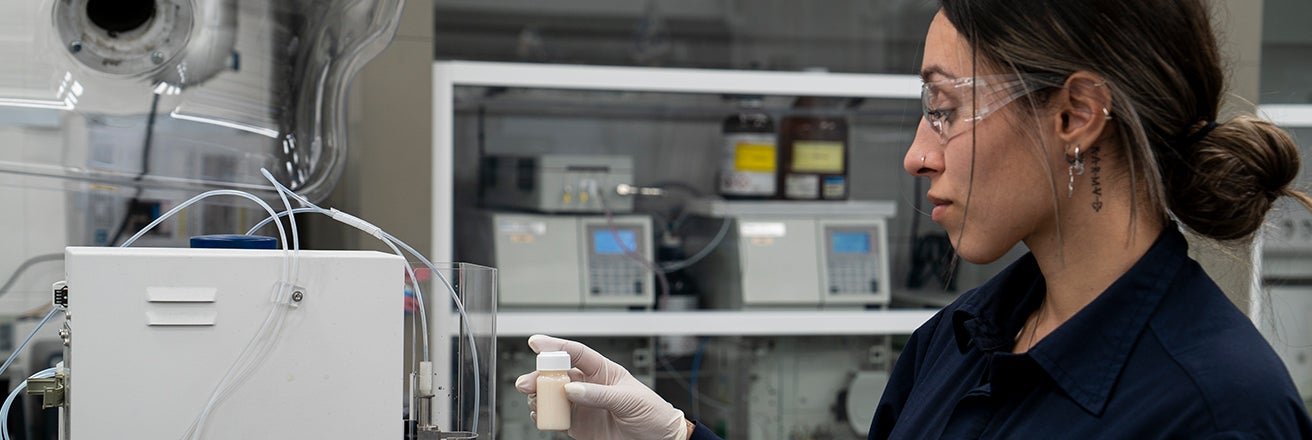 Female worker in laboratory examining chemicals