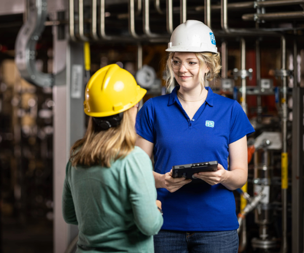 Two person talking on the manufacturing plant