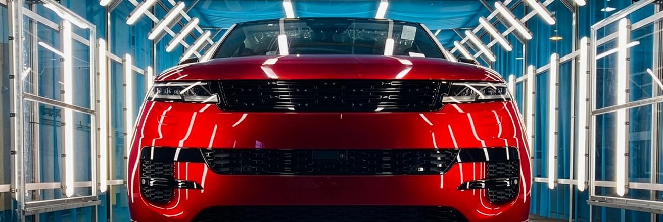 A red vehicle in a light booth