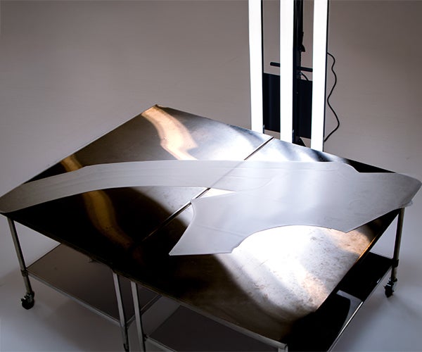 A table with a film cut out template on it