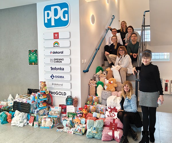 PPG employees next to array of donations for charity