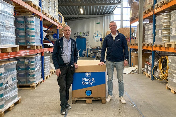 Morten Karlsen and Knud Schioldan, PPG employees within our Architectural Coatings business, in a warehouse with the PPG Plug & Spray solution