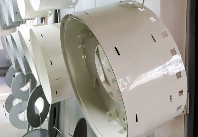 Metal components sprayed with white powder coating on a production line