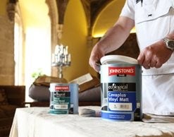 Painter opening cans of paint